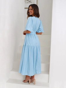 Detail of light blue dress showing waist pleats and elegant puff sleeve texture