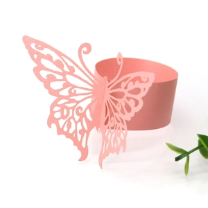 Macro detail of laser-cut pink butterfly napkin ring with delicate glitter texture