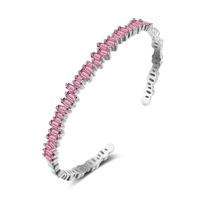 Macro detail of silver open bracelet featuring a row of rectangular pink zircon stones