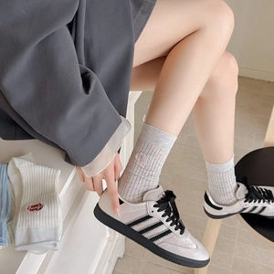 Retro grey suede sneakers with black stripes and embroidered crew socks set for women