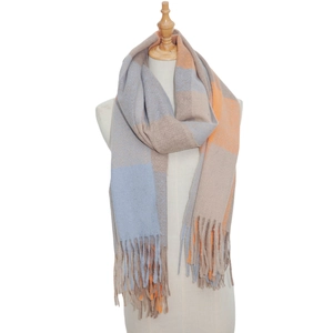 Close-up of soft plaid scarf showing thick tassel detail and fluffy checkered texture
