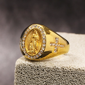 Macro shot of gold Virgin Mary ring with cross details and sparkling pavé diamonds