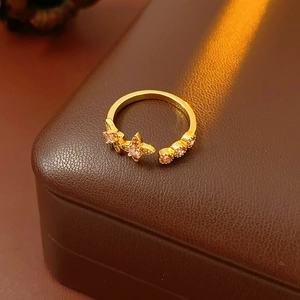 Close-up of gold vintage ring with star zircon accents on a premium leather box