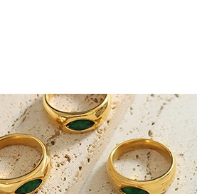 Detail view of gold-plated stainless steel rings with marquise green stone on stone base