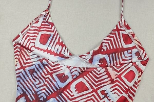 Close-up of deep V-neckline and fine straps on red geometric print halter dress