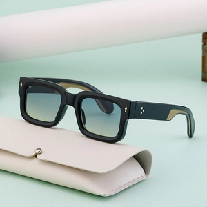 Vintage square sunglasses with black frame and blue-yellow gradient lenses on leather case