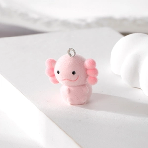 Detailed view of pink flocked axolotl charm pendant with silver metal loop on white tiers