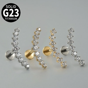 Macro view of G23 titanium labret studs with zircon and opal in silver and gold finishes