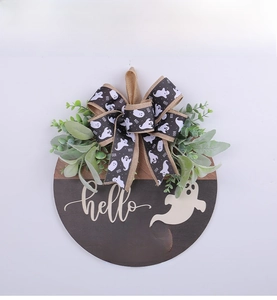 Close-up of wooden Halloween door sign with hello BOO text and ghost silhouette