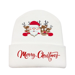 Close-up of white knitted hat featuring Merry Christmas text and cartoon reindeer print