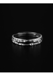 Detail of vintage silver ring featuring hand-hammered texture and black ripple design