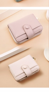 Detail view of pink litchi grain leather wallet with gold zipper and multi-card slots