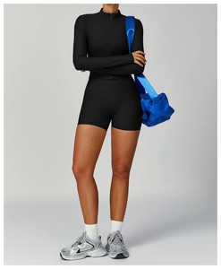 Detail of ribbed texture on black high-waisted yoga shorts and long sleeve top set