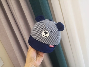 Close-up of navy blue striped baby sun hat featuring 3D bear ears and cute embroidery