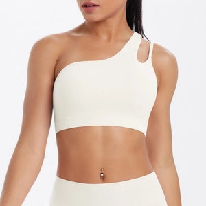Detailed view of cream-white asymmetric sports bra with double thin shoulder straps