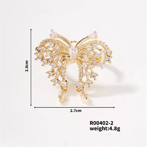 Detail view of gold butterfly ring with white zircon wings and dimensions 2.8cm x 2.7cm