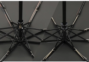 Macro shot of reinforced black umbrella ribs and metal mechanical slider joint