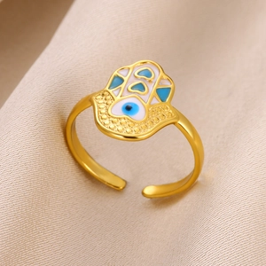 Detailed close-up of golden Hamsa Hand ring with blue enamel and evil eye pattern