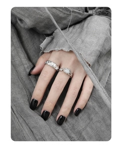Detail of silver S925 rings with irregular texture and gemstone on model hand