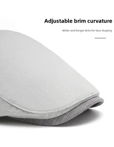 Detail of grey newsboy cap showing the foldable, widened brim for face slimming