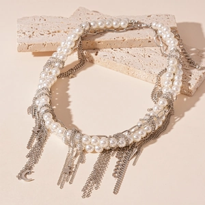 Multilayer faux pearl necklace with silver moon and star charms on beige stone blocks