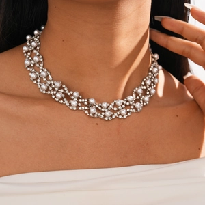 Close-up of double layer choker with sparkling rhinestones and pearls on intricate mesh