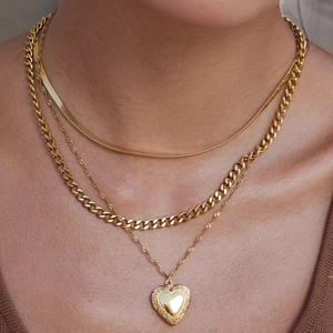 Three-layer gold necklace set featuring snake, cuban, and rope chains with a heart locket
