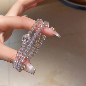 Macro detail of triple-layer faceted crystal bead bracelet with iridescent AB coating