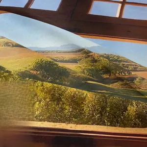 Close-up of high-density fabric texture with detailed mountain scenery landscape print