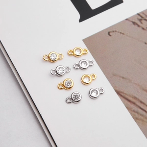 Detailed view of silver and gold 925 sterling silver charms with sparkling cubic zirconia