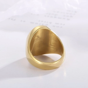 Macro shot of gold-plated signet ring featuring a brushed texture and polished finish