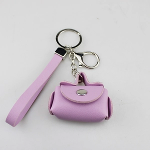 Detail view of a purple PU leather mini coin purse keychain with wrist strap