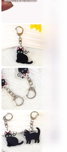 Detail of laser-cut black cat acrylic keychain with durable double-sided printing
