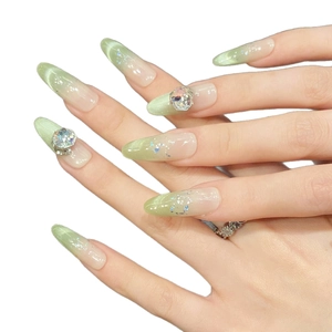 Matcha green cat-eye gradient press-on nails in long almond shape with rhinestones