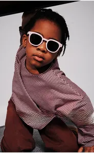 Close-up of stylish pink frames on children polarized sunglasses worn by a fashion model