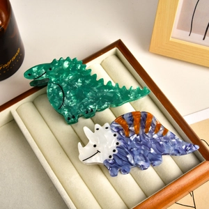 Cartoon dinosaur acetate hair claws with marble texture in green and triceratops styles