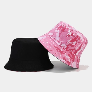 Detailed view of stackable camouflage and solid black canvas reversible bucket hats