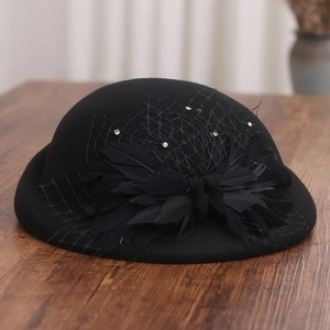 Detail of vintage wool felt hat with black feathers, mesh veil and sparkling rhinestones