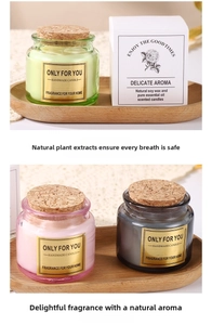Detailed set of soy wax candles in colored glass jars with natural cork lids and boxes