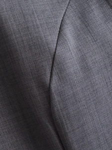 Detailed macro view of high-quality grey pleated fabric texture and precise stitching detail