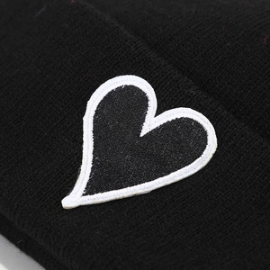 Black knit beanie hat for men and women featuring a heart patch with white stitching