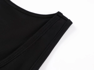 Detail of black sports tank top showing high-quality stitching and breathable knit fabric