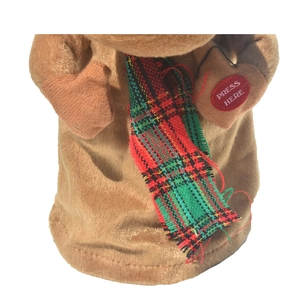 Detail of plush reindeer with red and green plaid scarf and Press Here button on hand