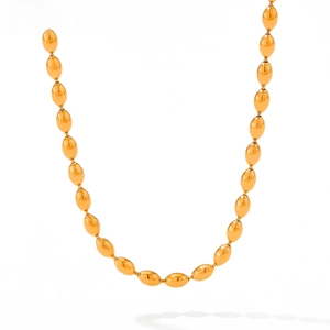 Detail of polished gold oval bead chain necklace with glossy stainless steel finish