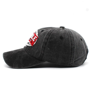 Detail of vintage washed dark gray cotton baseball cap with red embroidered patch