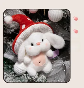 Gros plan d'un lapin en peluche blanc avec chapeau champignon rouge décor de Noël
