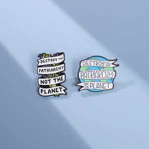Detail of enamel pins featuring slogans about planet protection and social awareness