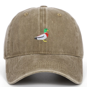 Macro detail of green duck embroidery on khaki washed cotton vintage baseball cap