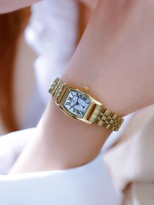 Close-up of elegant gold square quartz watch with Roman numerals on a woman's wrist