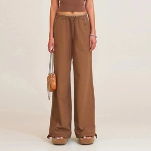 Brown wide-leg sports trousers featuring adjustable drawstrings and side seam detailing